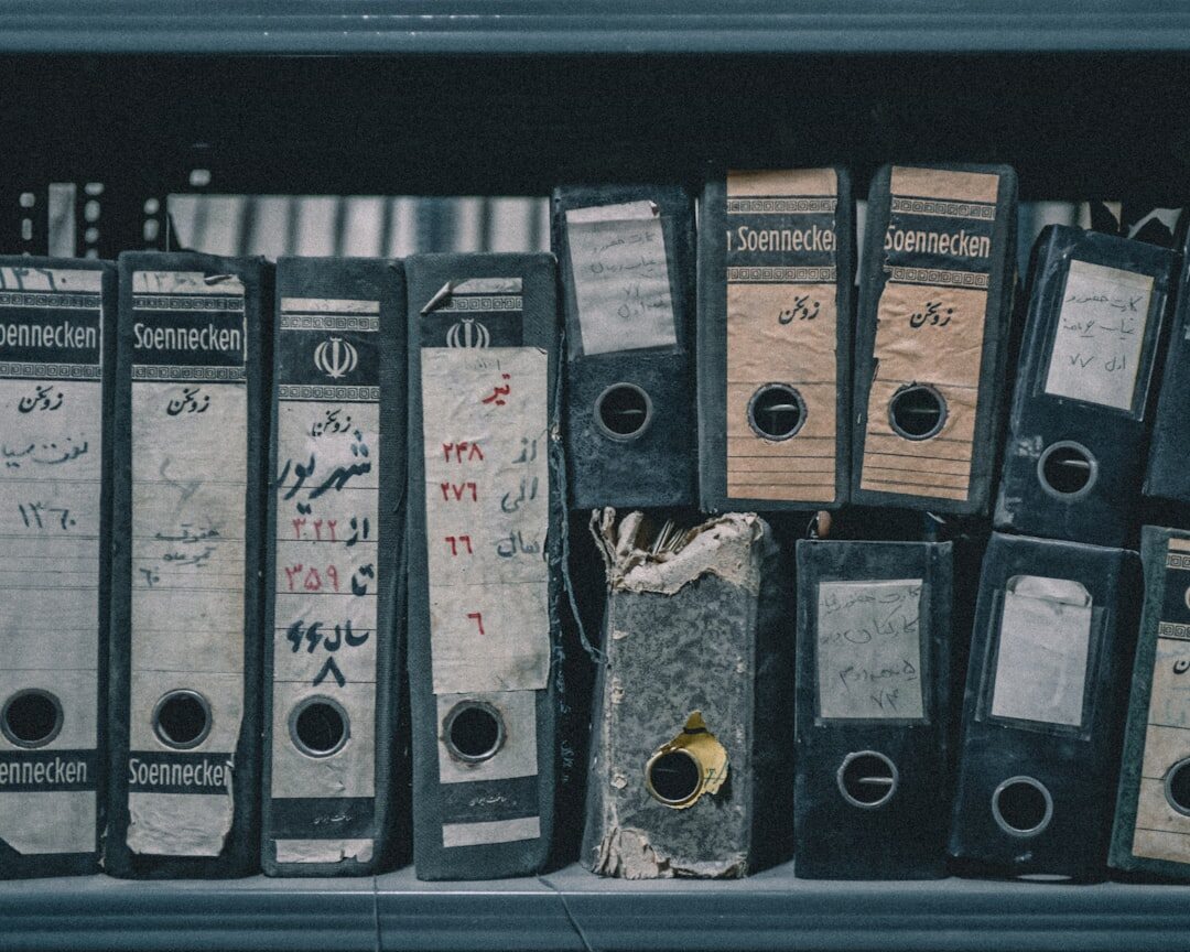 Rows of archival shelves filled with tapes and documents