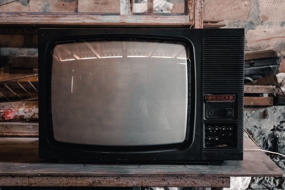 Retro CRT television set glowing in a dim room